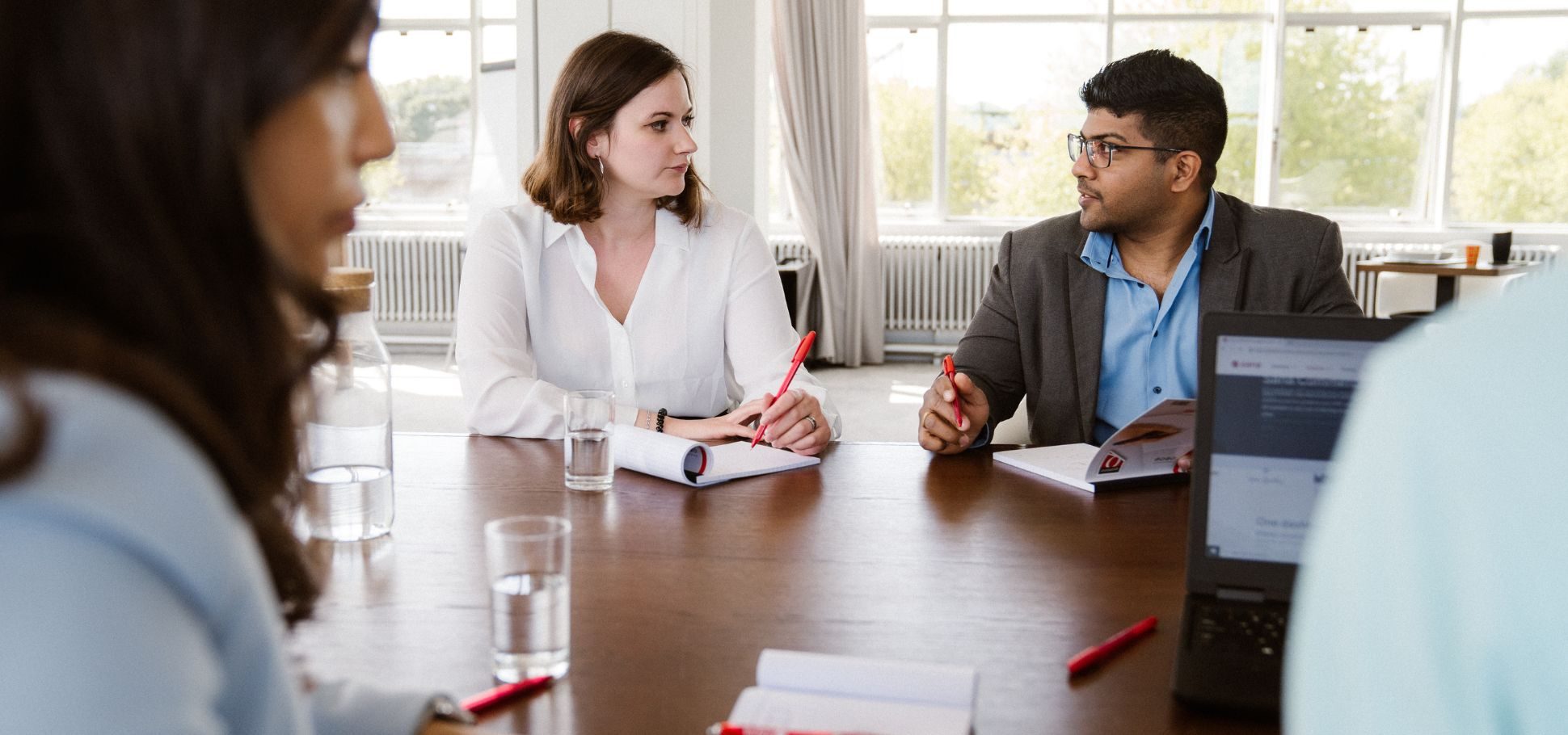 Two colleagues having a conversation in a meeting