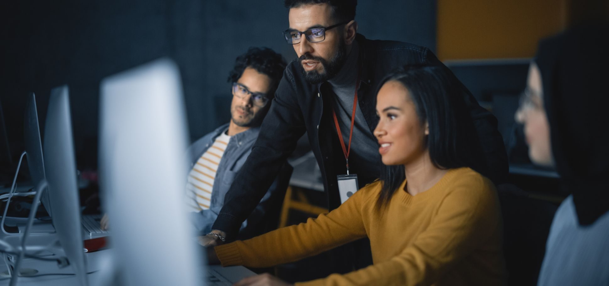 coworkers look at their computer screen