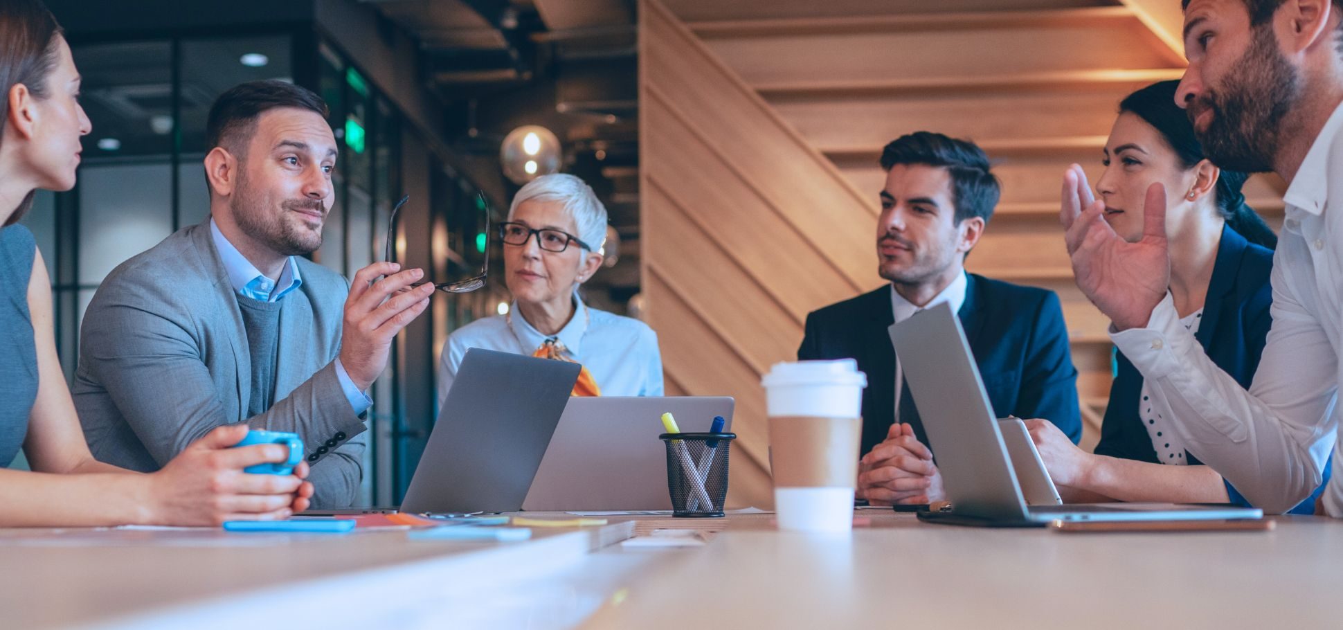 Colleagues discuss company performance in a conference room