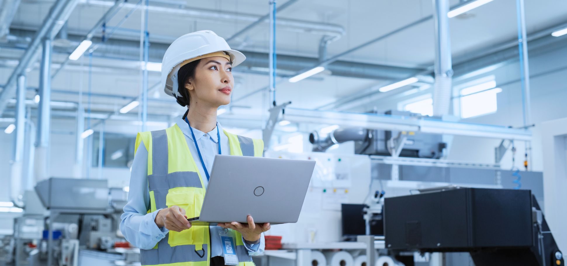 Female engineer tours factory while on digital tablet