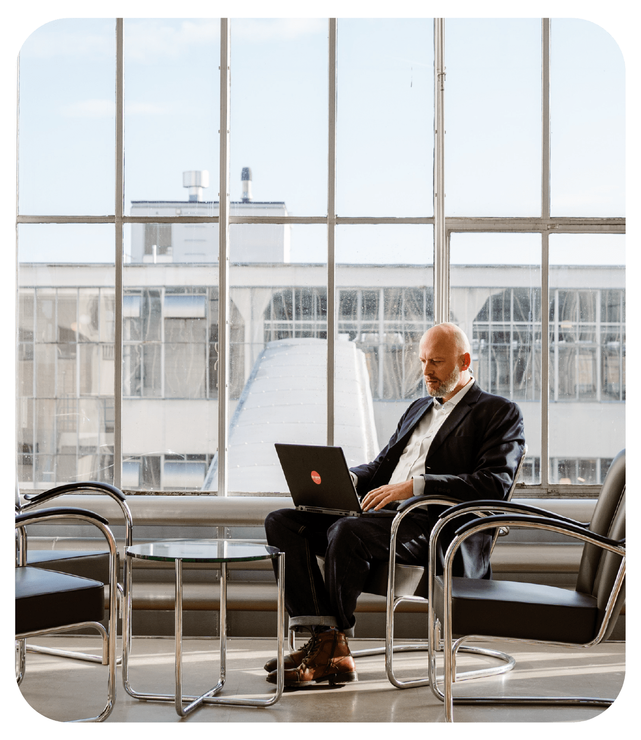 sana customer support team man siting in a chair working on a laptop