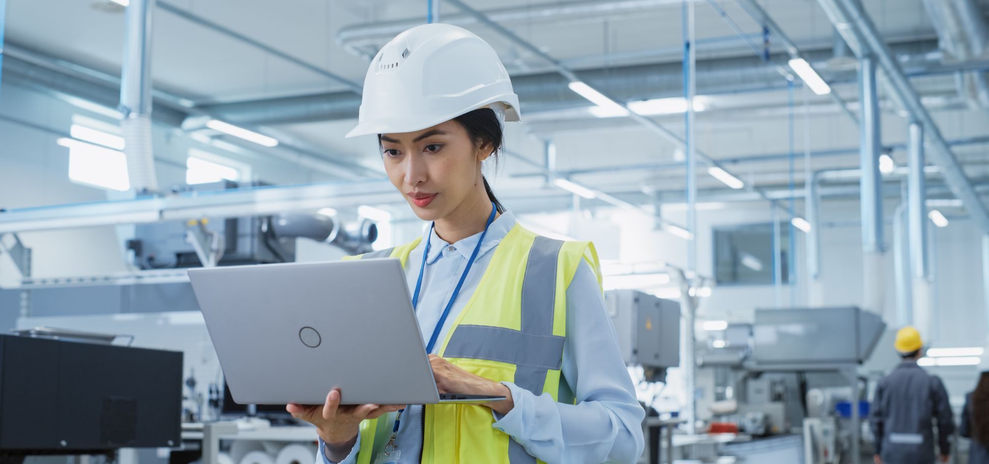 Woman orders something on her laptop in warehouse